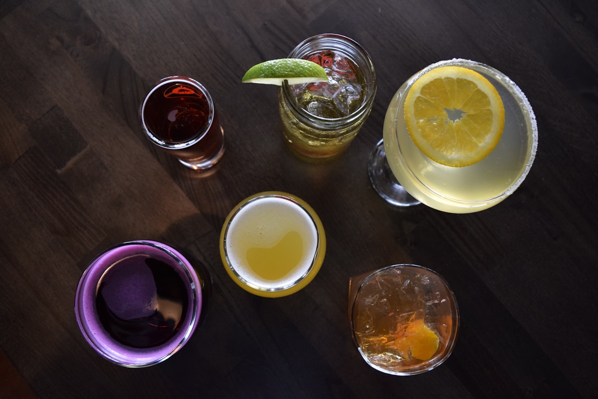 a group of glasses filled with different types of drinks